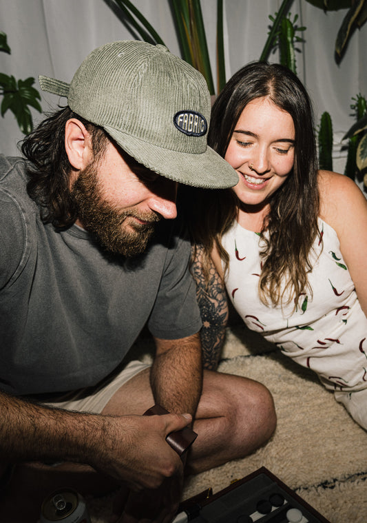 Man and woman sitting together with plants in the background